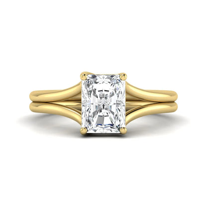 Radiant cut lab grown diamond solitaire engagement ring featuring a split shank band with a four-prong setting in polished yellow gold.