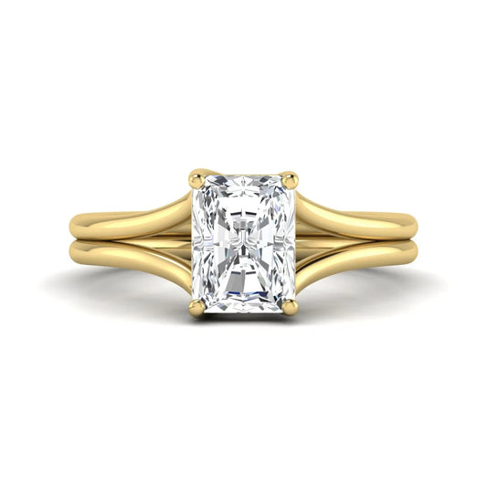 Radiant cut lab grown diamond solitaire engagement ring featuring a split shank band with a four-prong setting in polished yellow gold.