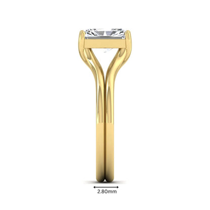Radiant cut lab grown diamond solitaire engagement ring featuring a split shank band with a four-prong setting in polished yellow gold.
