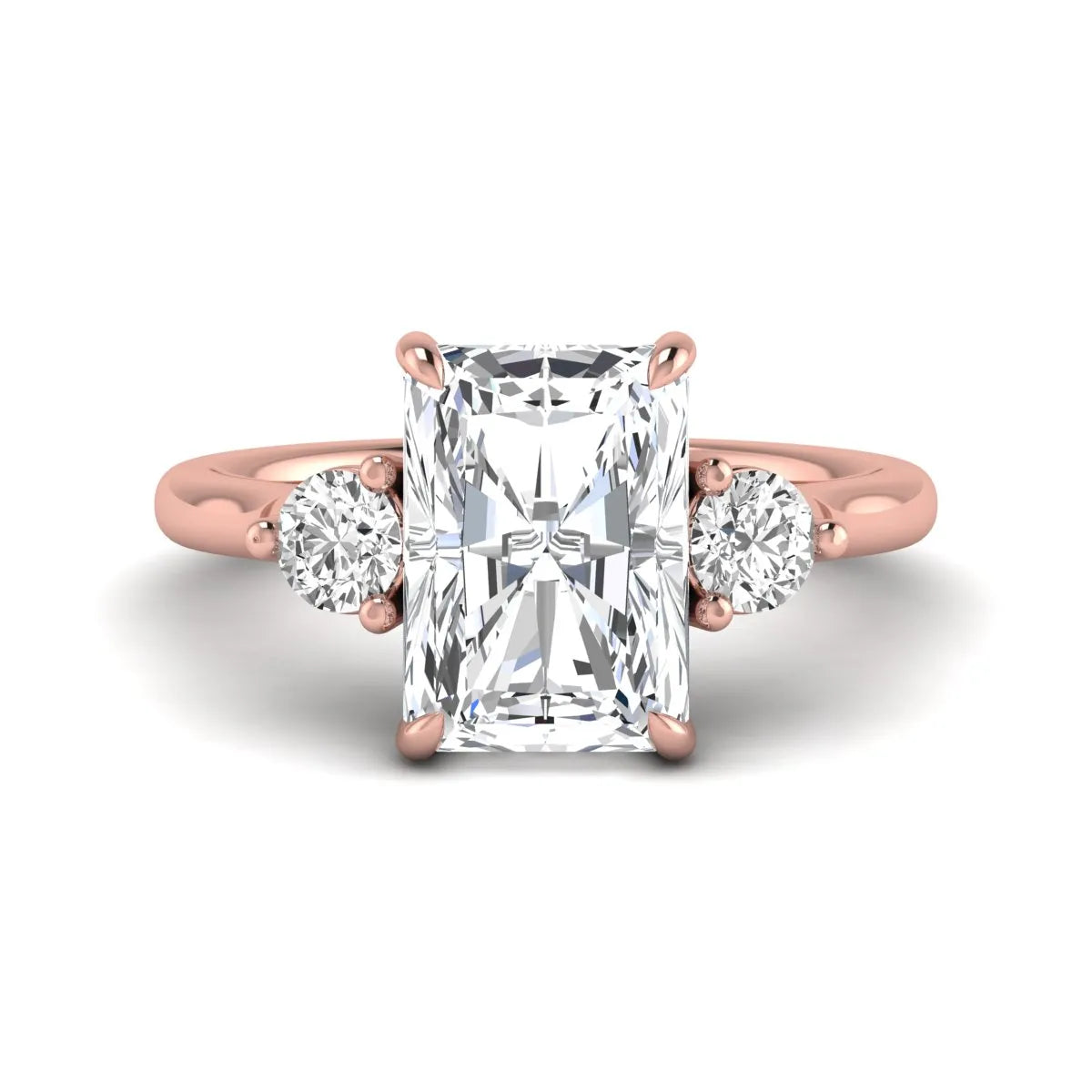 Radiant cut lab grown diamond three stone engagement ring with round side diamonds in a four-prong setting and rose gold tone band.