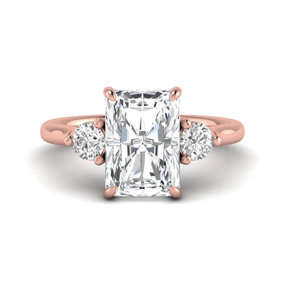 Radiant cut lab grown diamond three stone engagement ring with round side diamonds in a four-prong setting and rose gold tone band.
