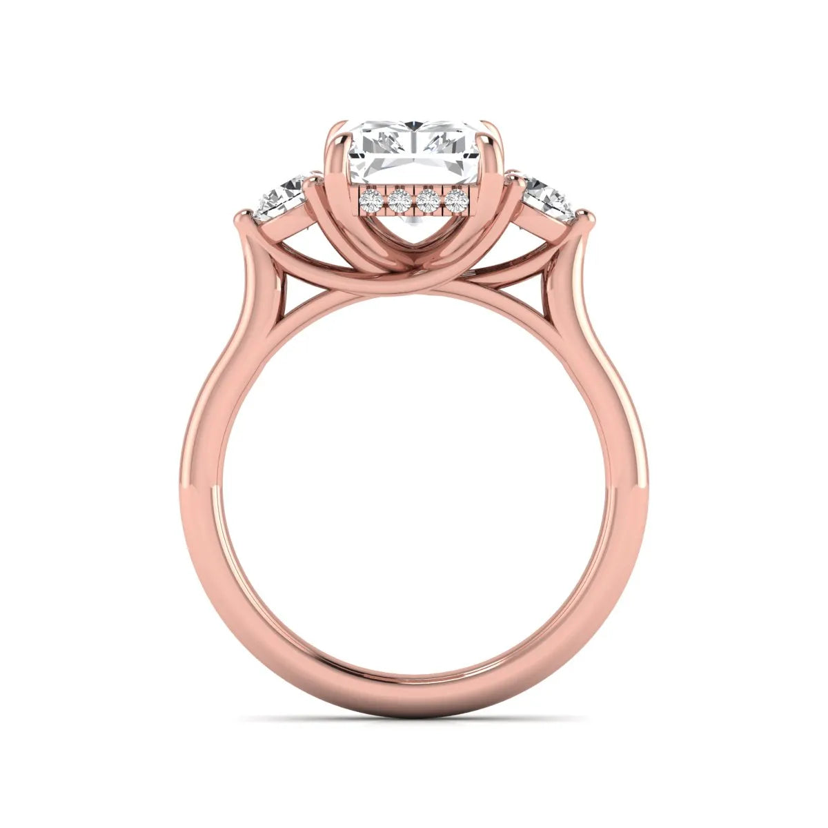 Radiant cut lab grown diamond three stone engagement ring with round side diamonds in a four-prong setting and rose gold tone band.