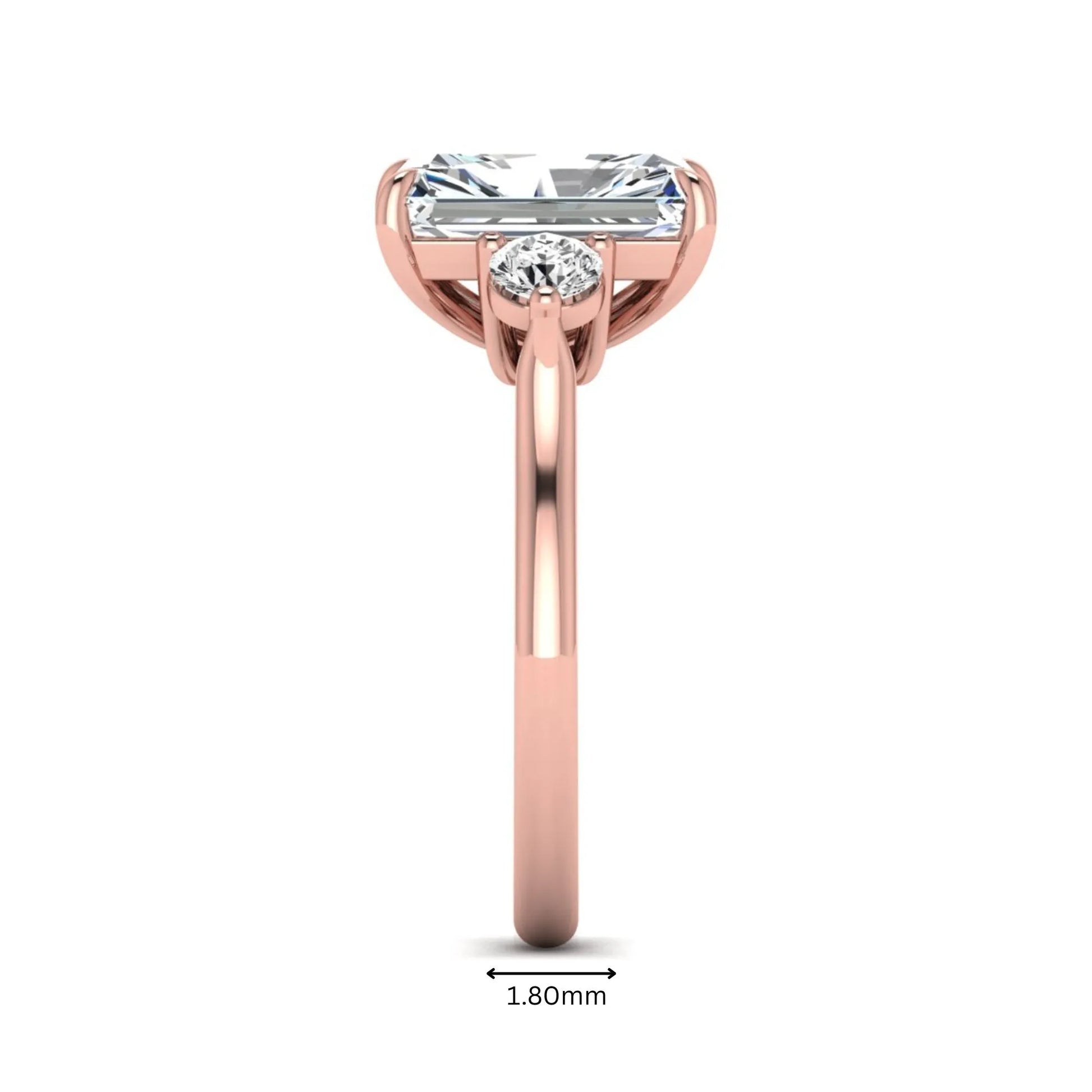 Radiant cut lab grown diamond three stone engagement ring with round side diamonds in a four-prong setting and rose gold tone band.