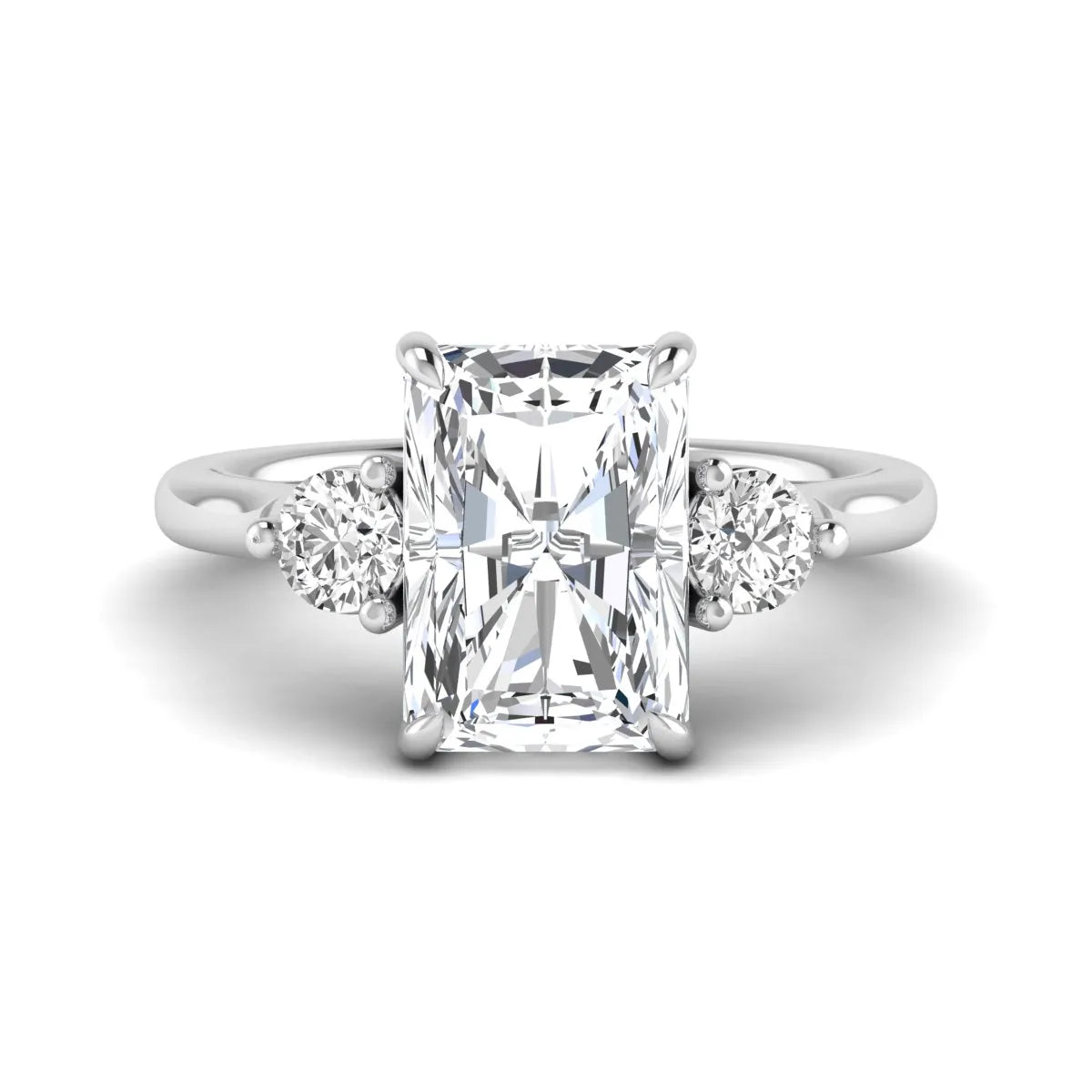 Radiant cut lab grown diamond three stone engagement ring with round side diamonds in a four-prong setting and white gold tone band.