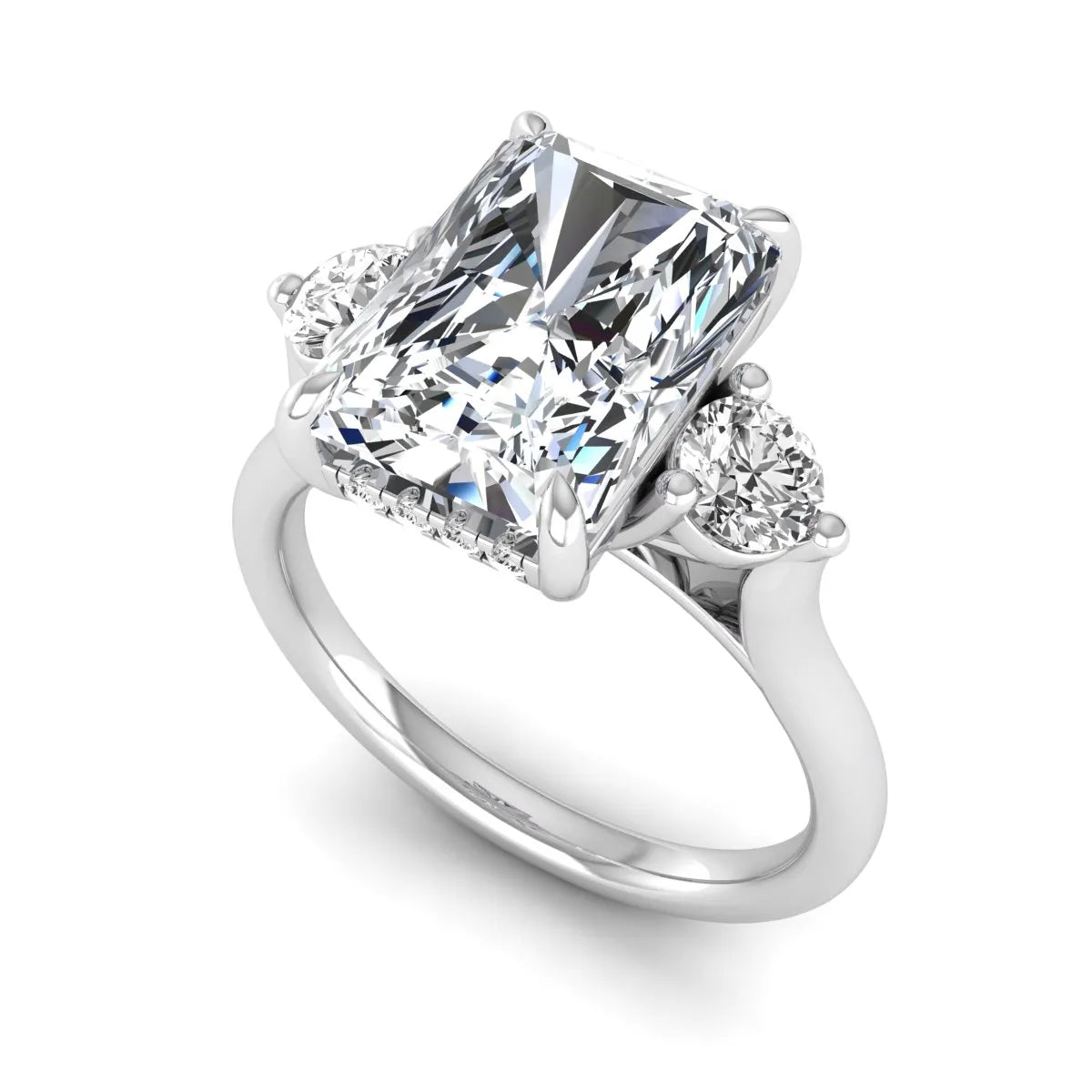 Radiant cut lab grown diamond three stone engagement ring with round side diamonds in a four-prong setting and white gold tone band.