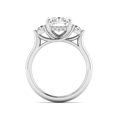 Radiant cut lab grown diamond three stone engagement ring with round side diamonds in a four-prong setting and white gold tone band.