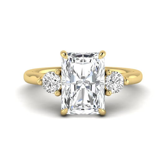 Radiant cut lab grown diamond three stone engagement ring with round side diamonds in a four-prong setting and yellow gold tone band.