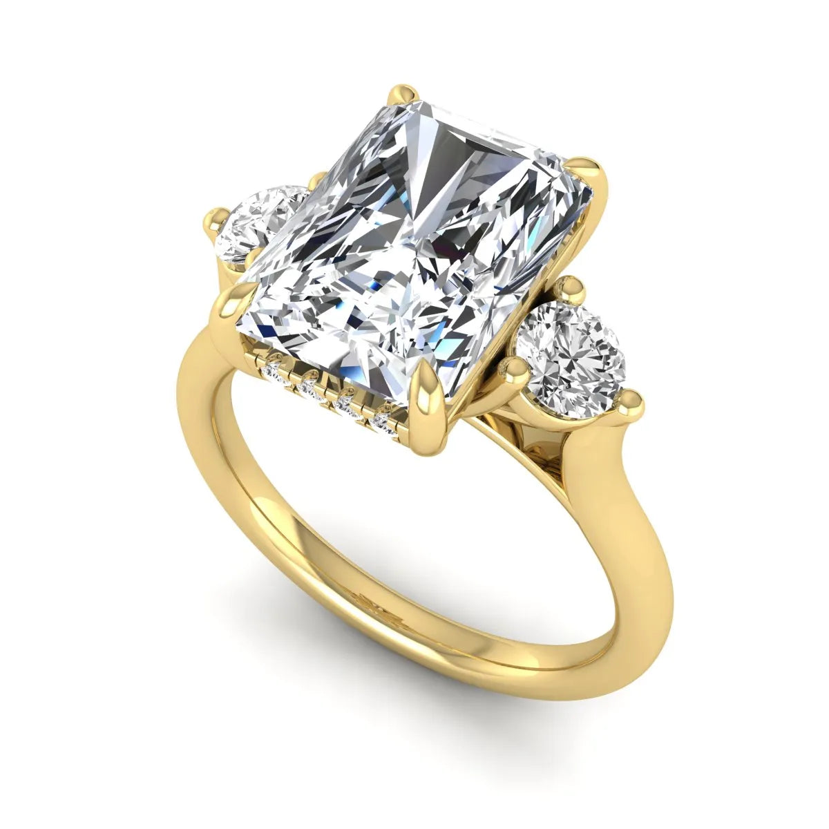 Radiant cut lab grown diamond three stone engagement ring with round side diamonds in a four-prong setting and yellow gold tone band.