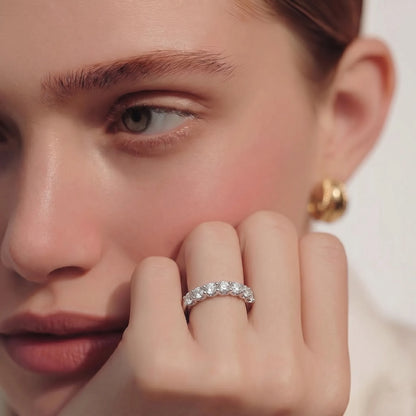 white-gold Close-up of a person wearing a diamond ring on a neutral background