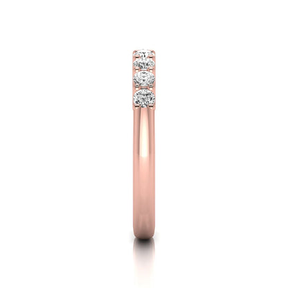 Rose-gold ring with three diamonds on a white background