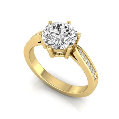 Round cut lab grown diamond engagement ring featuring a six-prong setting with round accent diamonds on a tapered yellow gold style band.