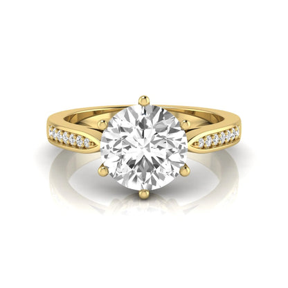 Round cut lab grown diamond engagement ring featuring a six-prong setting with round accent diamonds on a tapered yellow gold style band.