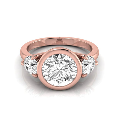 Round cut lab grown diamond three stone engagement ring with a bezel set center diamond and round side diamonds in rose gold