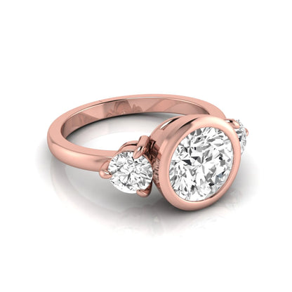 Round cut lab grown diamond three stone engagement ring with a bezel set center diamond and round side diamonds in rose gold
