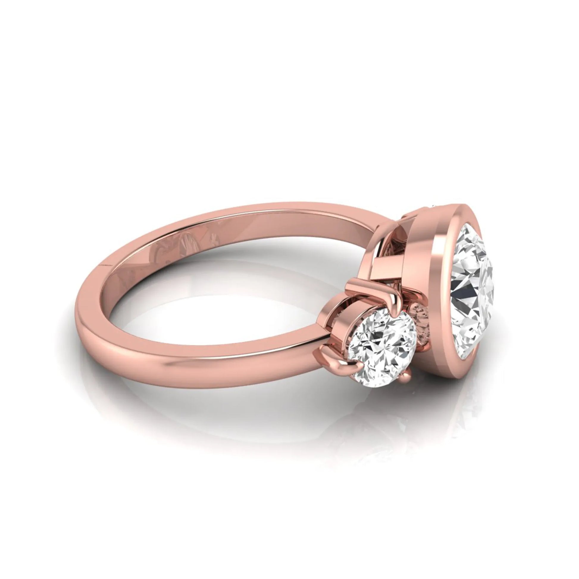 Round cut lab grown diamond three stone engagement ring with a bezel set center diamond and round side diamonds in rose gold