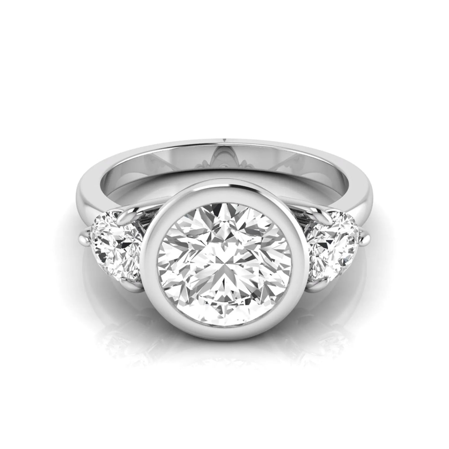 Round cut lab grown diamond three stone engagement ring with a bezel set center diamond and round side diamonds in white gold