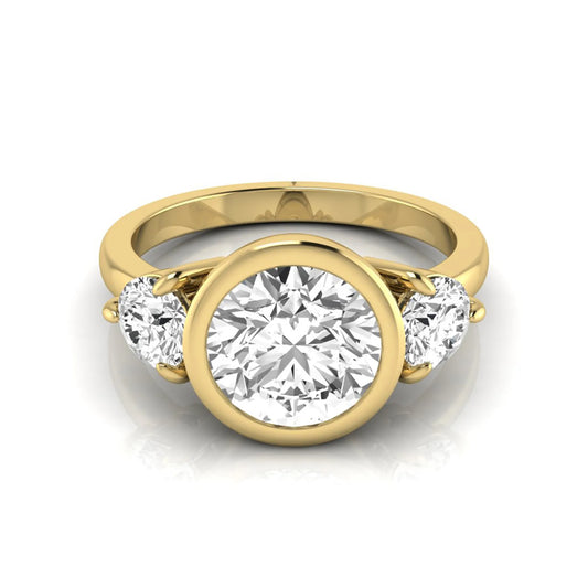 Round cut lab grown diamond three stone engagement ring with a bezel set center diamond and round side diamonds in yellow gold