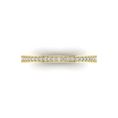 Round channel set lab grown diamond half eternity band ring featuring brilliant round diamonds in a slim stackable wedding band design in yellow gold