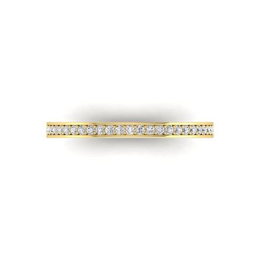 Round channel set lab grown diamond half eternity band ring featuring brilliant round diamonds in a slim stackable wedding band design in yellow gold