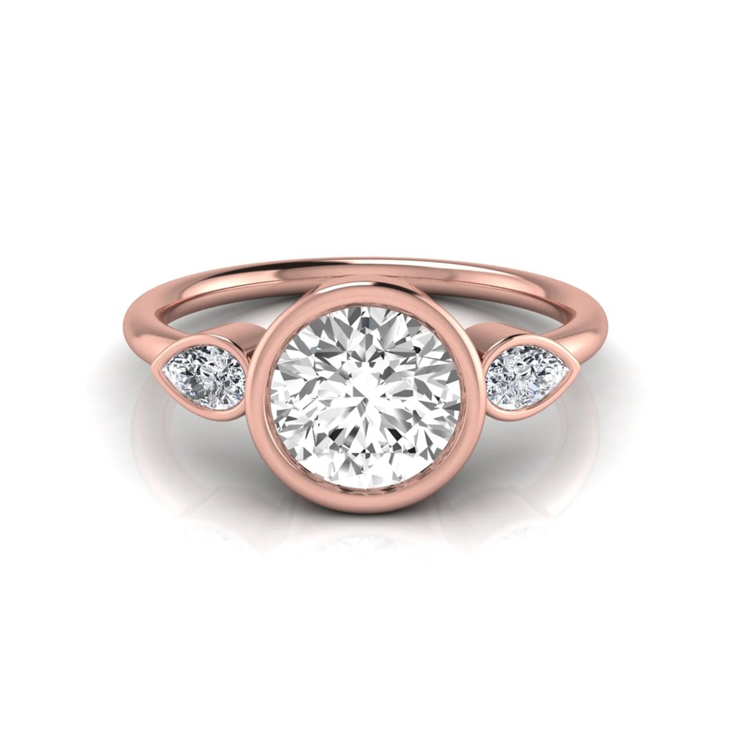 Round cut lab grown diamond bezel three stone engagement ring featuring a 1.28 carat IGI certified center diamond with pear cut side diamonds in rose gold.