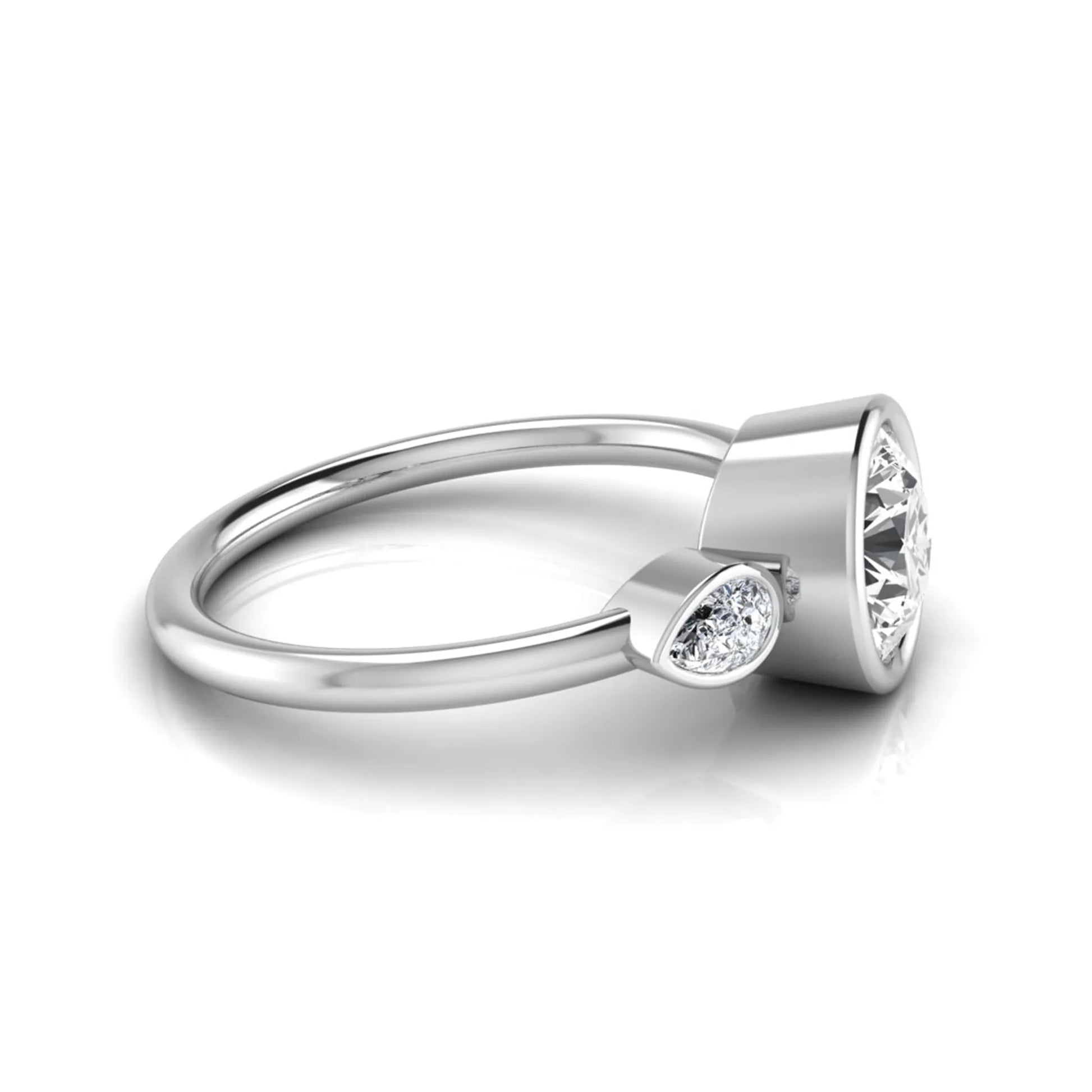 Round cut lab grown diamond bezel three stone engagement ring featuring a 1.28 carat IGI certified center diamond with pear cut side diamonds in white gold.