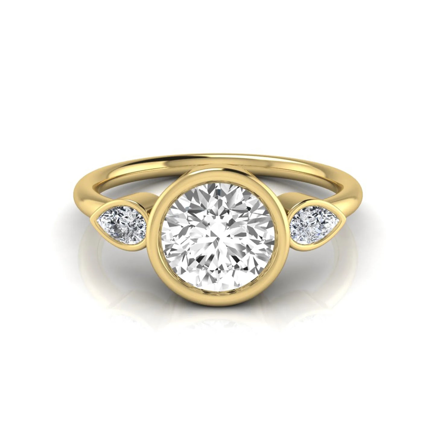 Round cut lab grown diamond bezel three stone engagement ring featuring a 1.28 carat IGI certified center diamond with pear cut side diamonds in yellow gold.