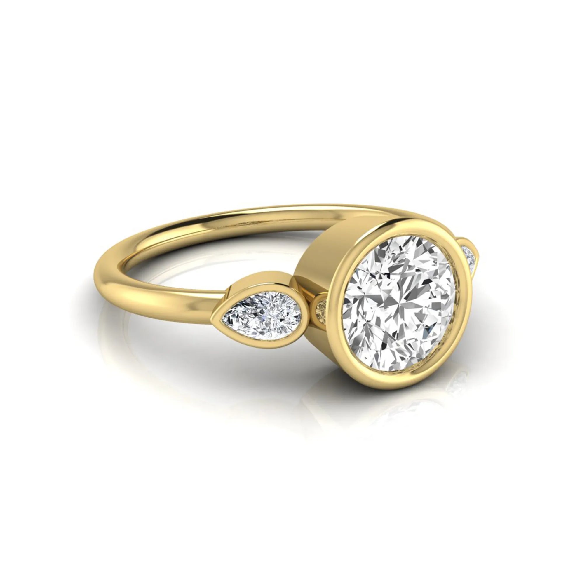 Round cut lab grown diamond bezel three stone engagement ring featuring a 1.28 carat IGI certified center diamond with pear cut side diamonds in yellow gold.