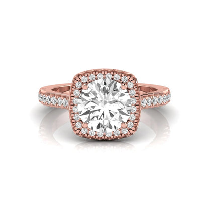 Round cut lab grown diamond halo engagement ring featuring a four-prong center setting with a pavé diamond band in rose gold tone.