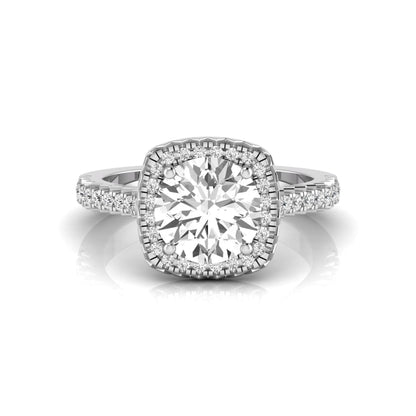 Round cut lab grown diamond halo engagement ring featuring a four-prong center setting with a pavé diamond band in white gold tone.