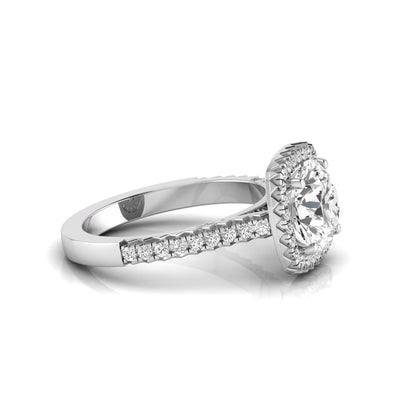 Round cut lab grown diamond halo engagement ring featuring a four-prong center setting with a pavé diamond band in white gold tone.