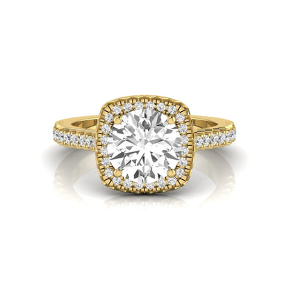 Round cut lab grown diamond halo engagement ring featuring a four-prong center setting with a pavé diamond band in yellow gold tone.