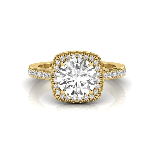 Round cut lab grown diamond halo engagement ring featuring a four-prong center setting with a pavé diamond band in yellow gold tone.