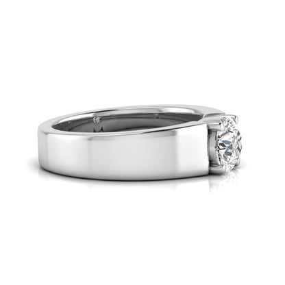 Round cut lab grown diamond solitaire engagement ring featuring a four-prong setting with a wide white gold tone comfort-fit band.