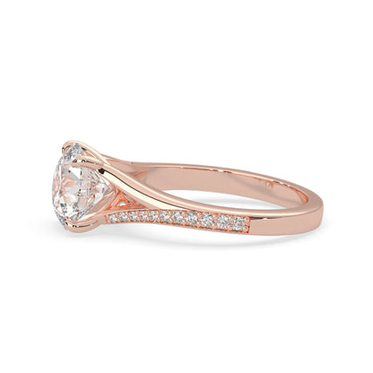 Rose gold ring with a large diamond and smaller diamonds on the band against a white background
