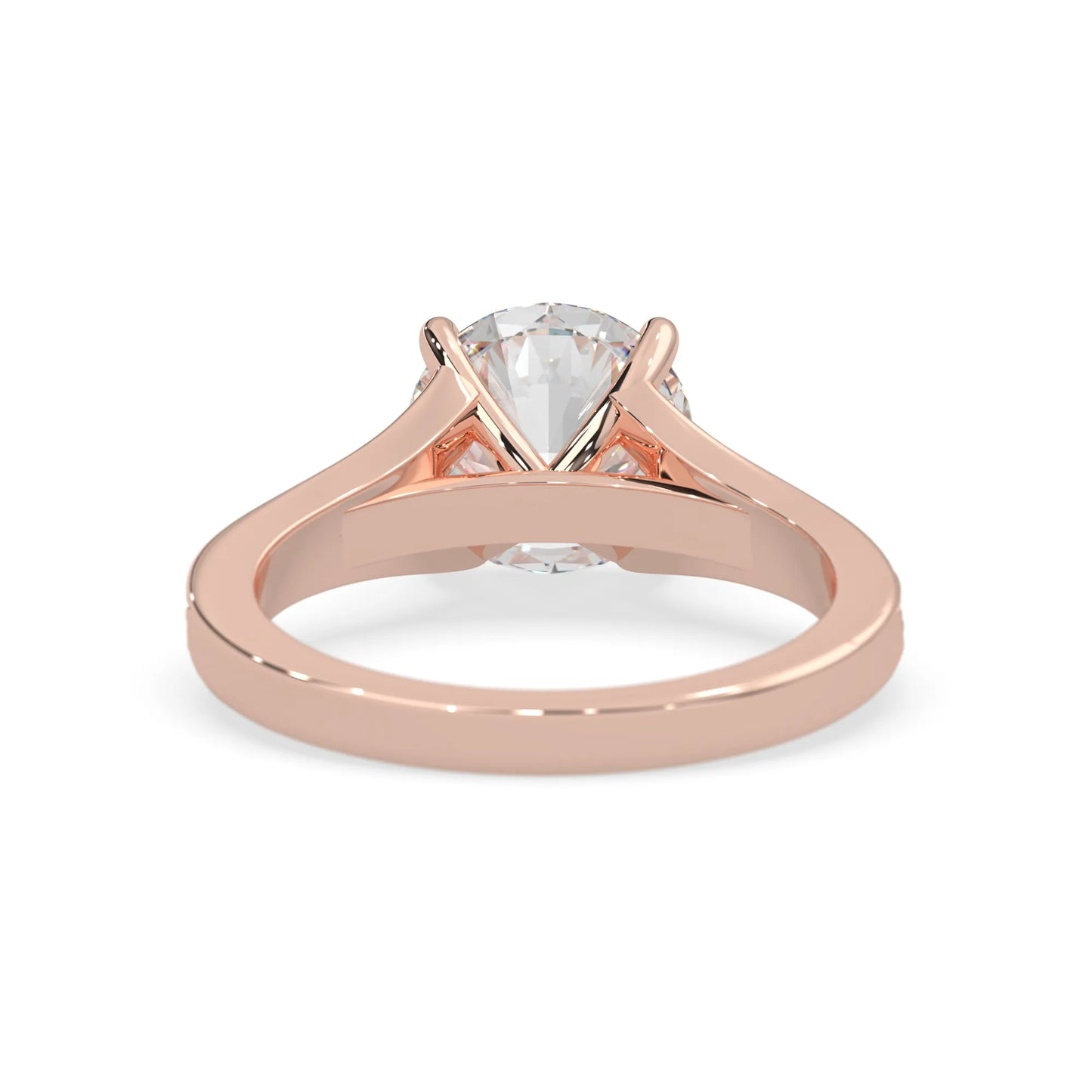Rose gold ring with a clear gemstone on a white background
