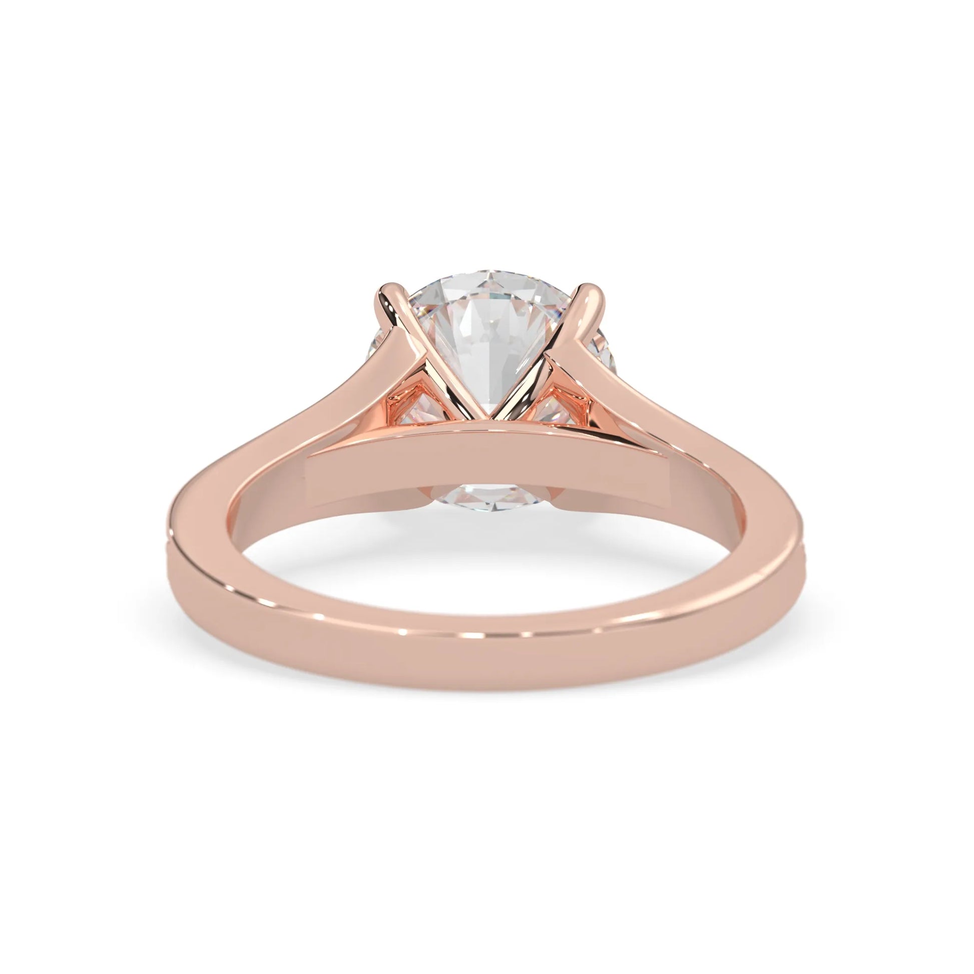 Rose gold ring with a clear gemstone on a white background