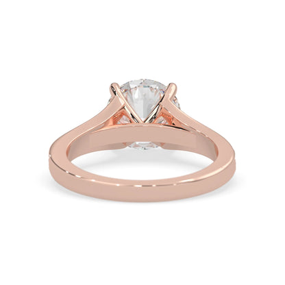 Rose gold ring with a clear gemstone on a white background