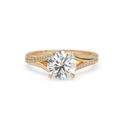 yellow gold ring with a large diamond and smaller diamonds on the band against a white background