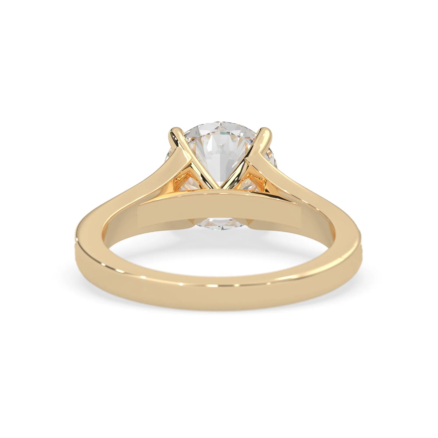 yellow Gold ring with a clear gemstone on a white background