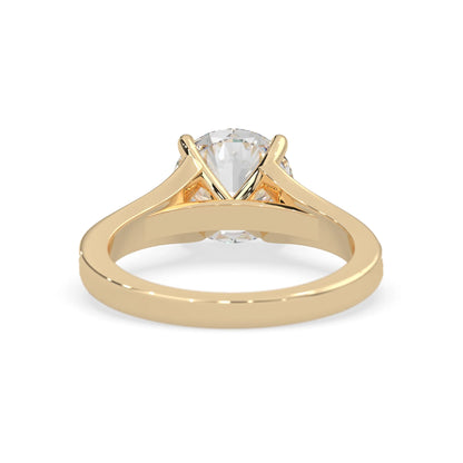yellow Gold ring with a clear gemstone on a white background