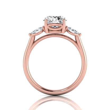 Round cut lab grown diamond three stone engagement ring featuring a 2.04 carat IGI certified center diamond with pear side diamonds in rose gold