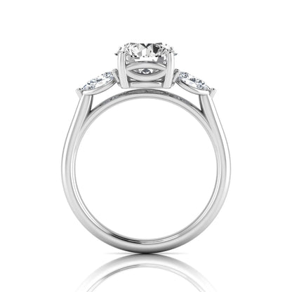 Round cut lab grown diamond three stone engagement ring featuring a 2.04 carat IGI certified center diamond with pear side diamonds in white gold