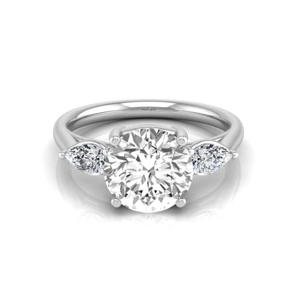 Round cut lab grown diamond three stone engagement ring featuring a 2.04 carat IGI certified center diamond with pear side diamonds in white gold