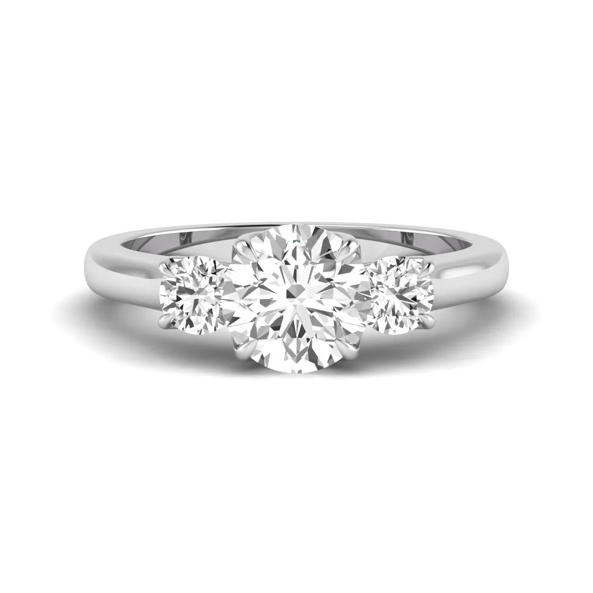 IGI certified round cut lab grown diamond three stone engagement ring with round side diamonds in white gold.