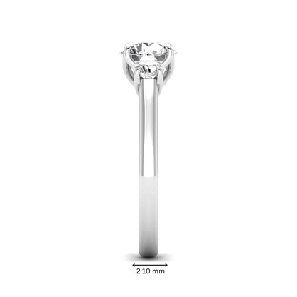 IGI certified round cut lab grown diamond three stone engagement ring with round side diamonds in white gold.
