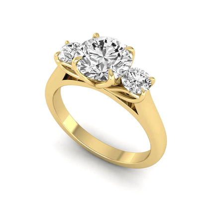 IGI certified round cut lab grown diamond three stone engagement ring with round side diamonds in yellow gold.
