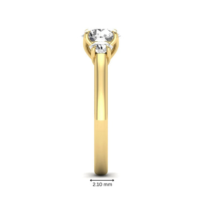 IGI certified round cut lab grown diamond three stone engagement ring with round side diamonds in yellow gold.