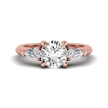 IGI certified round cut lab grown diamond three stone engagement ring with pear side diamonds in rose gold.