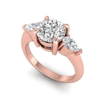 IGI certified round cut lab grown diamond three stone engagement ring with pear side diamonds in rose gold.