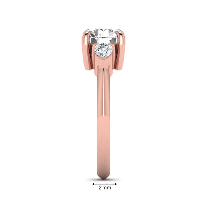 IGI certified round cut lab grown diamond three stone engagement ring with pear side diamonds in rose gold.
